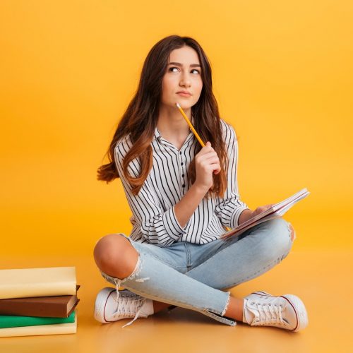 portrait-pensive-young-girl-making-notes_171337-1646